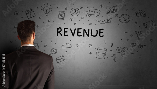businessman drawing a creative idea sketch with REVENUE inscription, business strategy concept