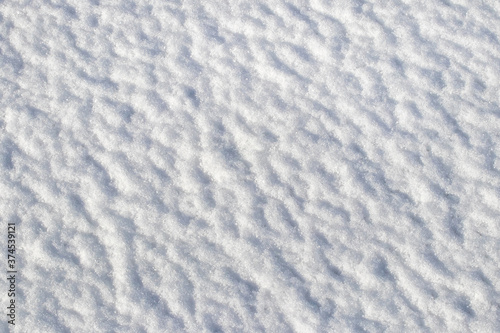 Snow texture in sunny weather, winter background