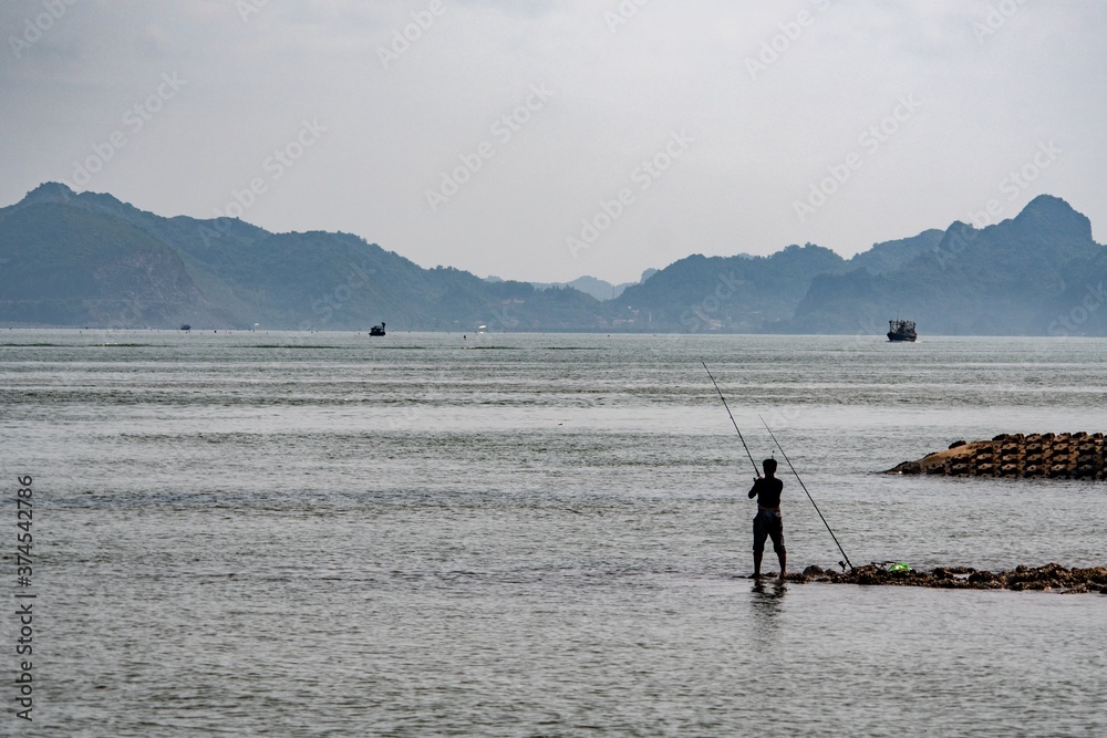 Naklejka premium fishing on the beach