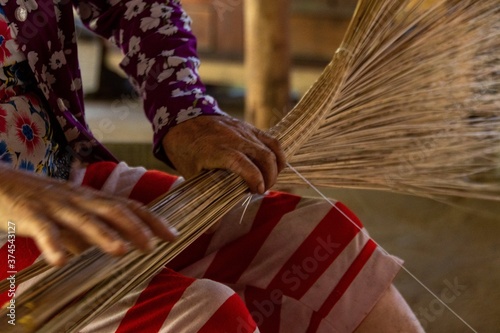 woman work on palm tree leaf