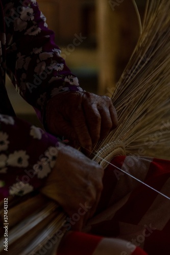 woman work on palm tree leaf