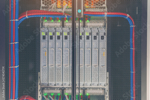 Rack Mounted Servers In A Server Room, Server rack audio cable. Severs computer in a rack at the large data center. photo