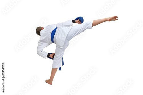 On white isolated background in karategi boy athlete trains kick