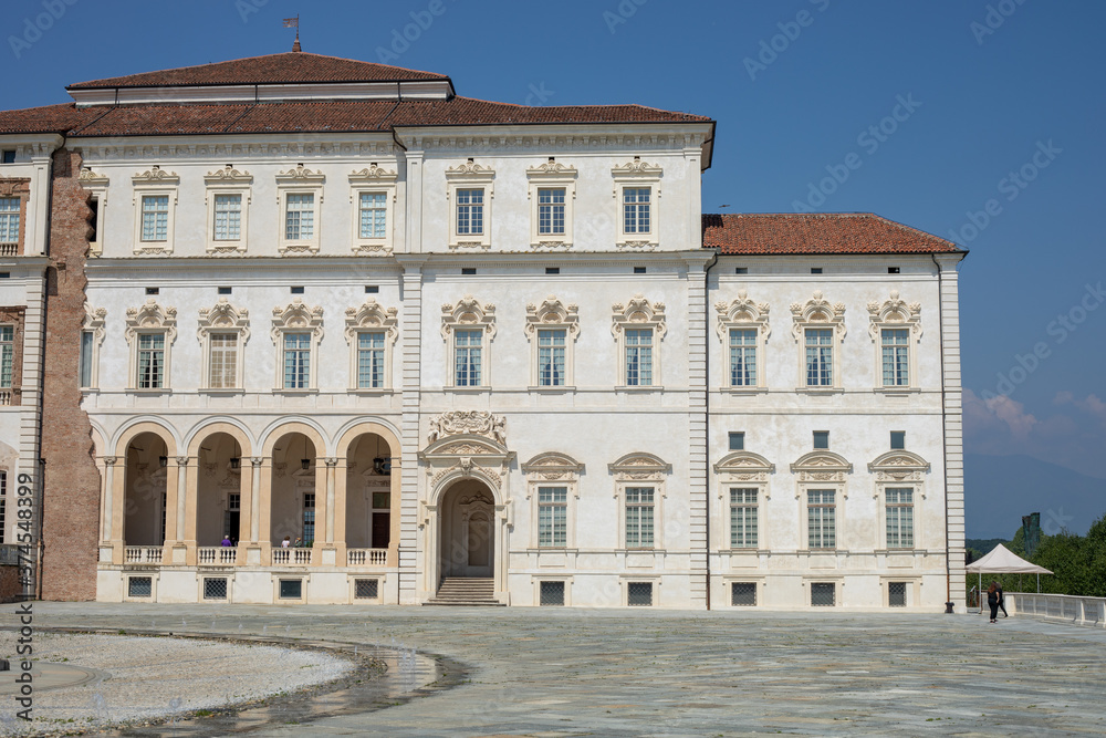 Exterior of Venaria Reale king palace in Turin, Italy, with garden and roses.