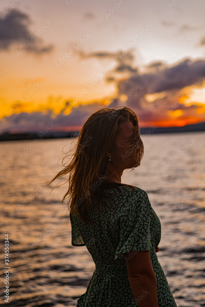 woman on a beach at sunset woman on a beach at sunset