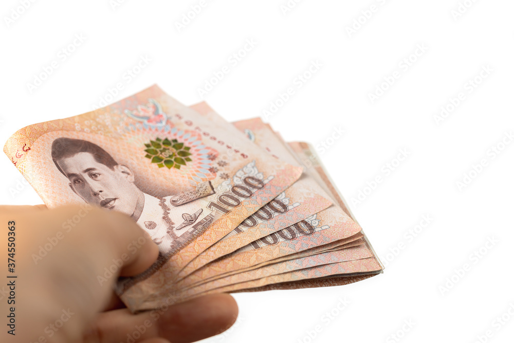 Φωτογραφία Hand holding Thai currency, 1000 Baht, money banknote of Thailand on white backg