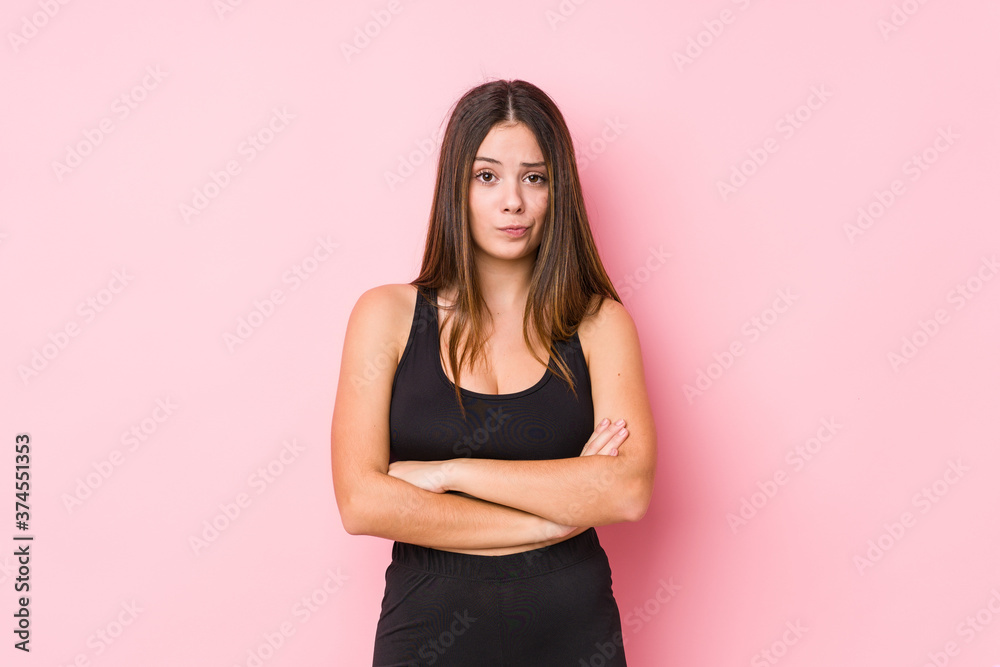 Young fitness caucasian woman isolated unhappy looking in camera with sarcastic expression. Young fitness caucasian woman isolated unhappy looking in camera with sarcastic expression.