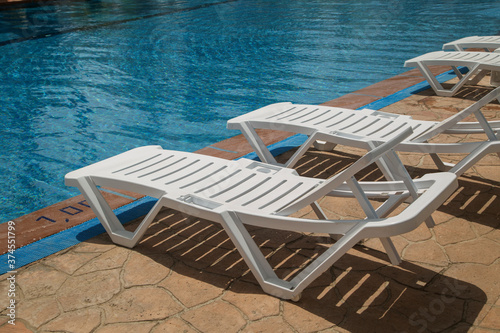 empty beach chairs by the pool