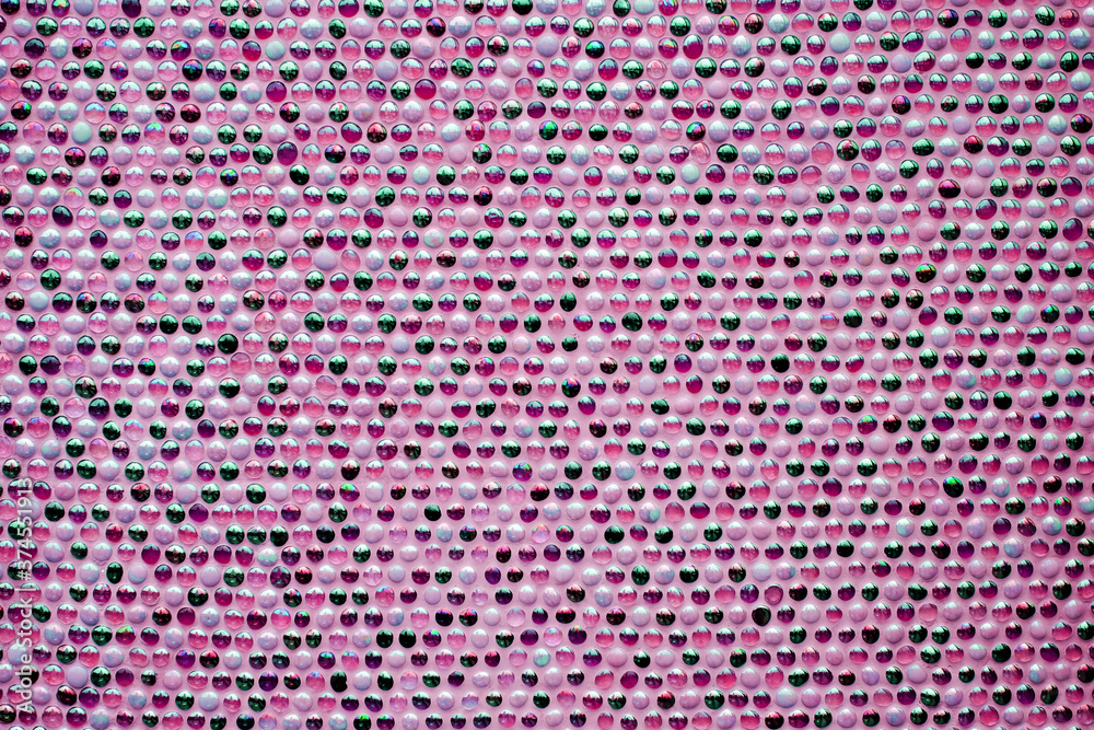 Pattern of many small round spheres - a lamp surface with variable backlit colors.