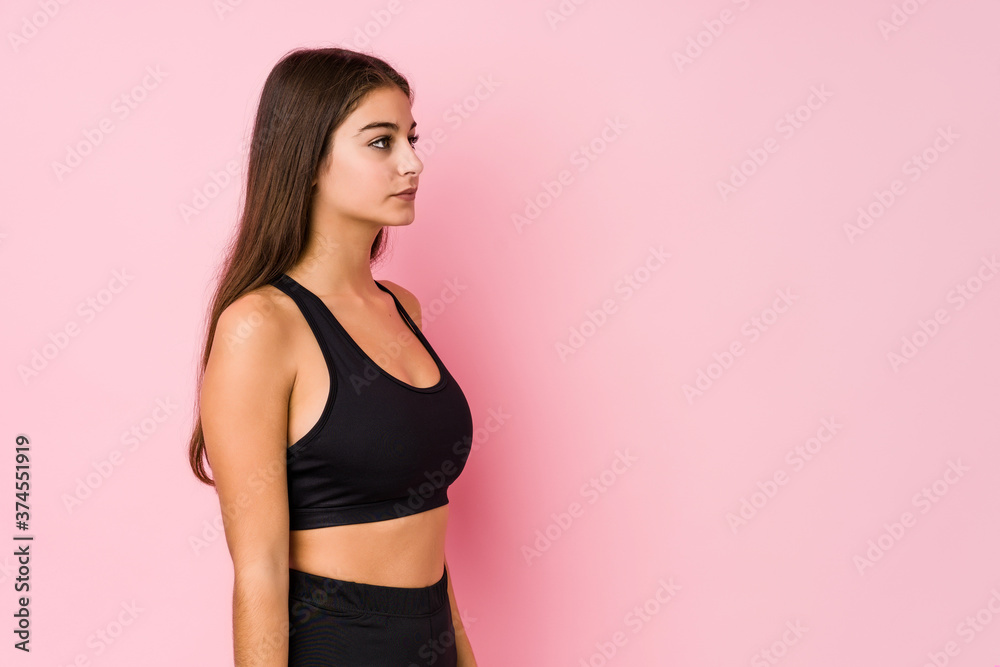 Young caucasian fitness woman doing sport isolated gazing left, sideways pose. Young caucasian fitness woman doing sport isolated gazing left, sideways pose.