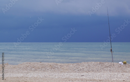 Storm Clouds over the sea with waves in the foreground. Good weather for fishing.