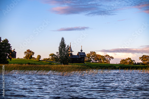 ancient churches on the island at sunset on the background of the lake © константин константи