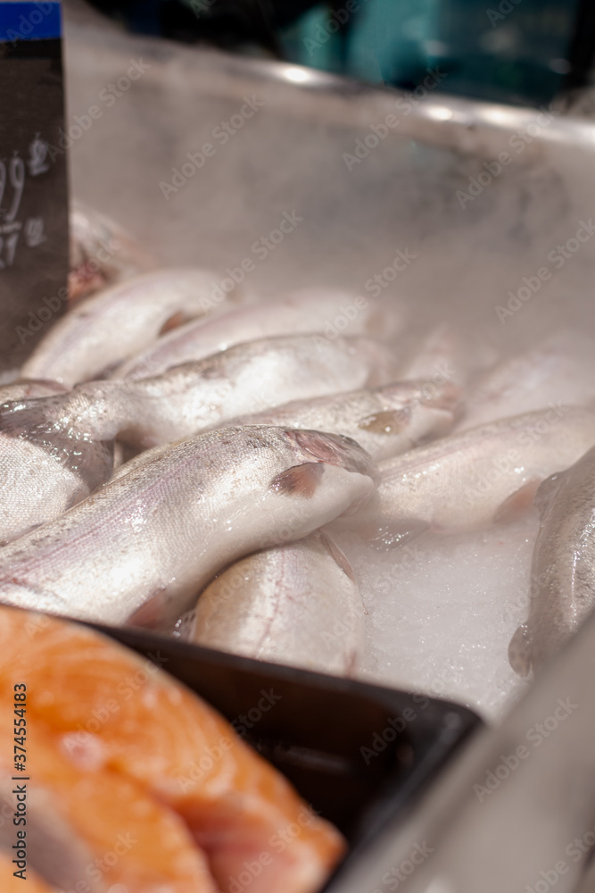 Fresh fish in ice on the market close-up. Selective focus. Fresh fish in ice on the market close-up. Selective focus.