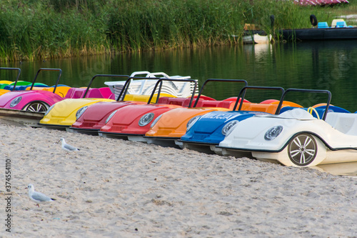 car-shaped pedal boats moored to the beach