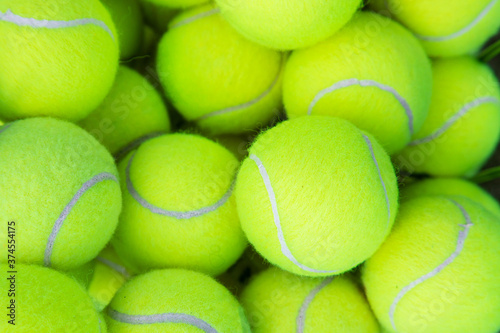 tennis balls in a basket on the court © AvokadoStudio