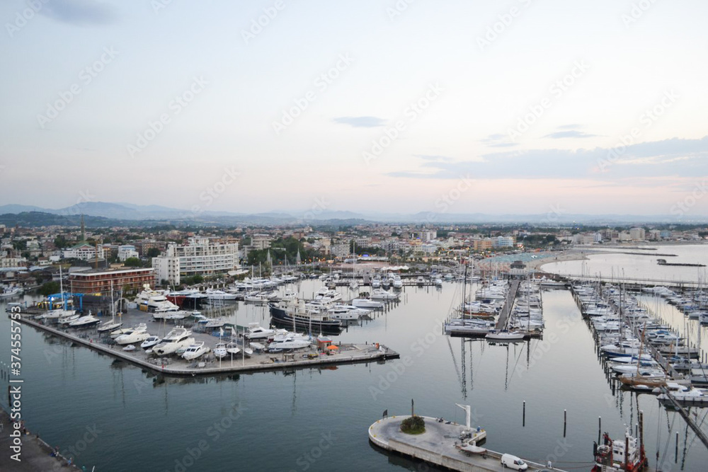 yachts on the pier, sea coast, evening panorama of the sea.  a small town by the sea.  sunset over the sea. many boats in the port