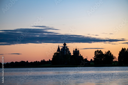 vintage churches on the island at sunrise on the background of the lake