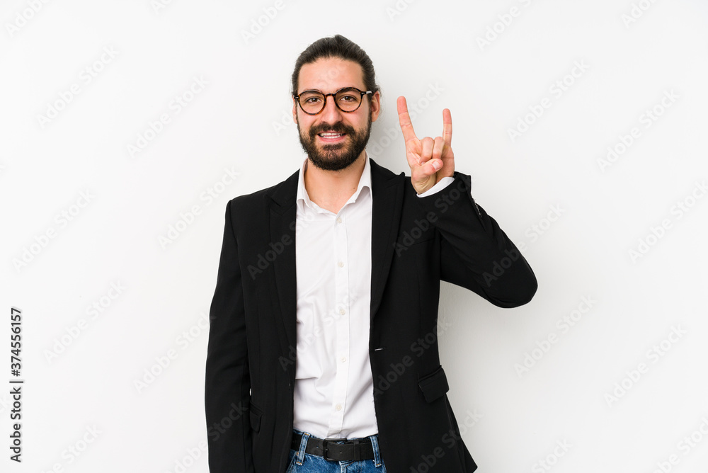Young caucasian business man isolated on a white background showing a horns gesture as a revolution concept. Young caucasian business man isolated on a white background showing a horns gesture as a revolution concept.