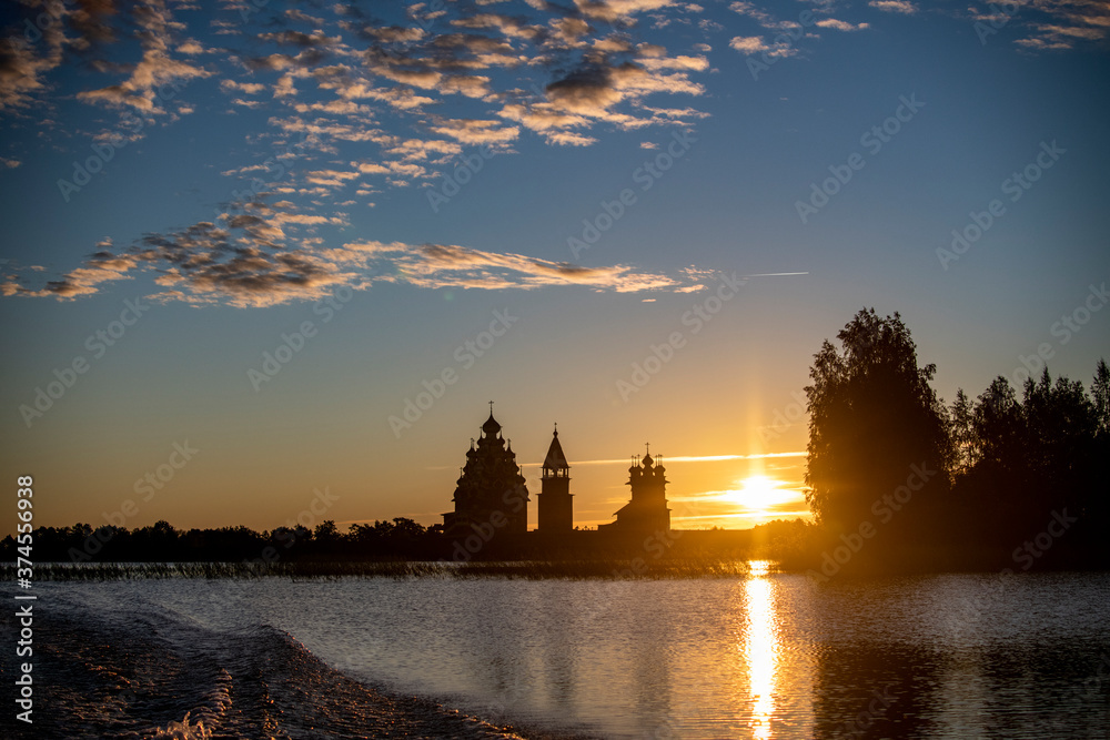 vintage churches on the island at sunrise on the background of the lake