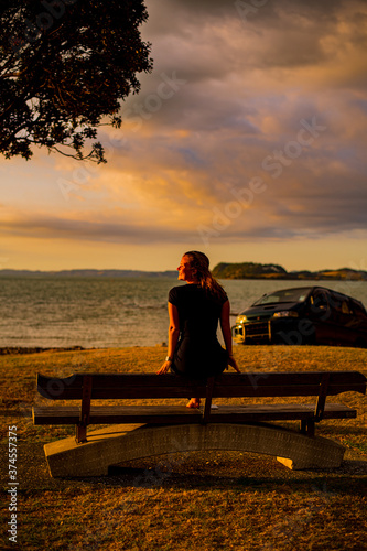 silhouette of a woman sitting on a bench