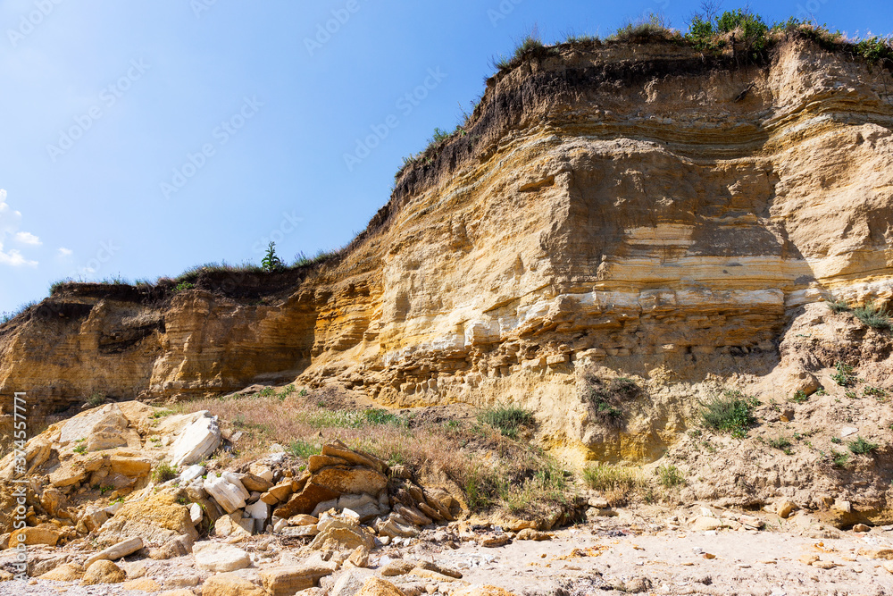 Landslide slope of mountain. Danger of rockfall, descent of stone avalanches. Mountain landscape of dangerous stony surfaces. Landslide slope of mountain. Danger of rockfall, descent of stone avalanches. Mountain landscape of dangerous stony surfaces.