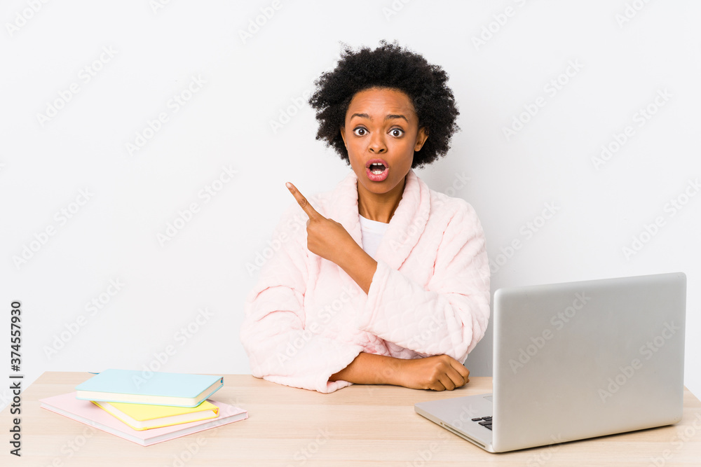 Middle aged african american woman working at home isolated pointing to the side Middle aged african american woman working at home isolated pointing to the side