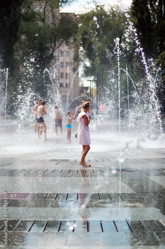 Summer. Dry Fountain. The girl bathes in the fountain.