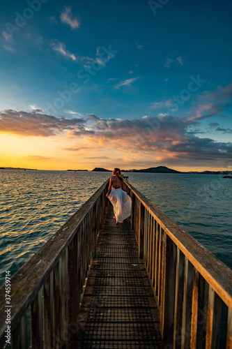 Fototapeta Naklejka Na Ścianę i Meble -  woman on a pier at sunset