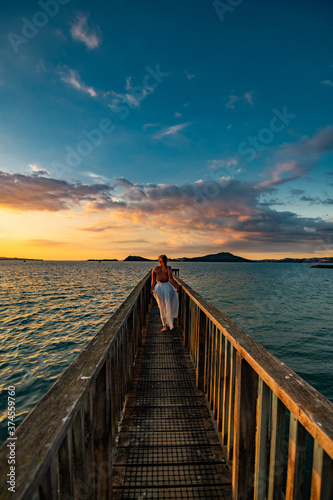 woman on a pier at sunset