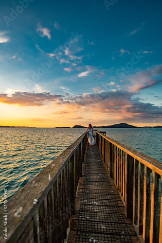 woman on a pier at sunset © Ingmar