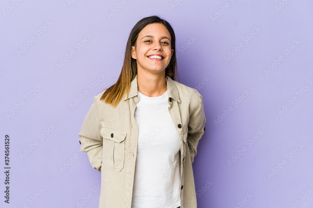 Young woman isolated on purple background happy, smiling and cheerful. Young woman isolated on purple background happy, smiling and cheerful.