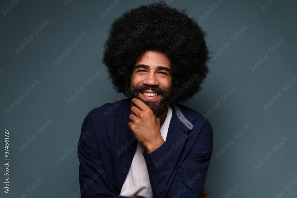 Beautiful afro man in front of a colored background Beautiful afro man in front of a colored background