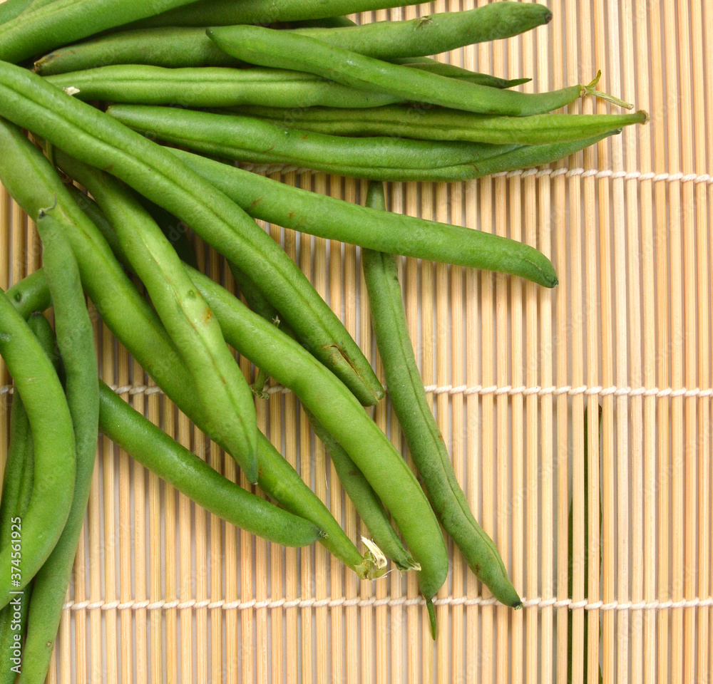 small and slender green beans (haricot vert) on a bamboo mat small and slender green beans (haricot vert) on a bamboo mat