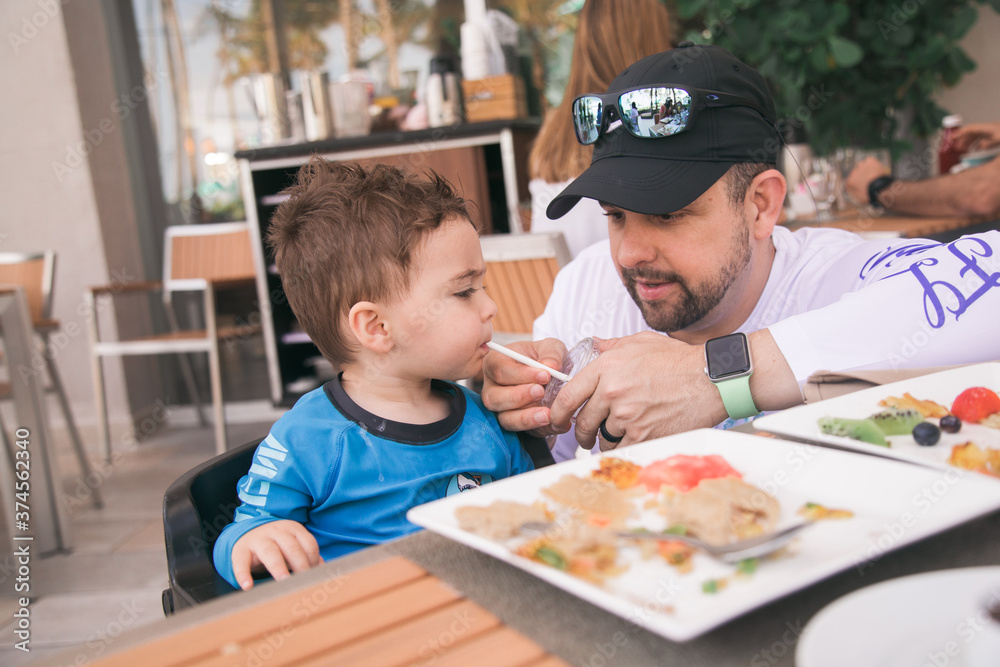 Puerto rico food and sites old san juan man feeding his son at a hotel Puerto rico food and sites old san juan man feeding his son at a hotel