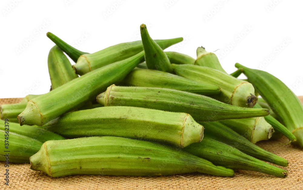 Lady Fingers or Okra isolated on burlap on white