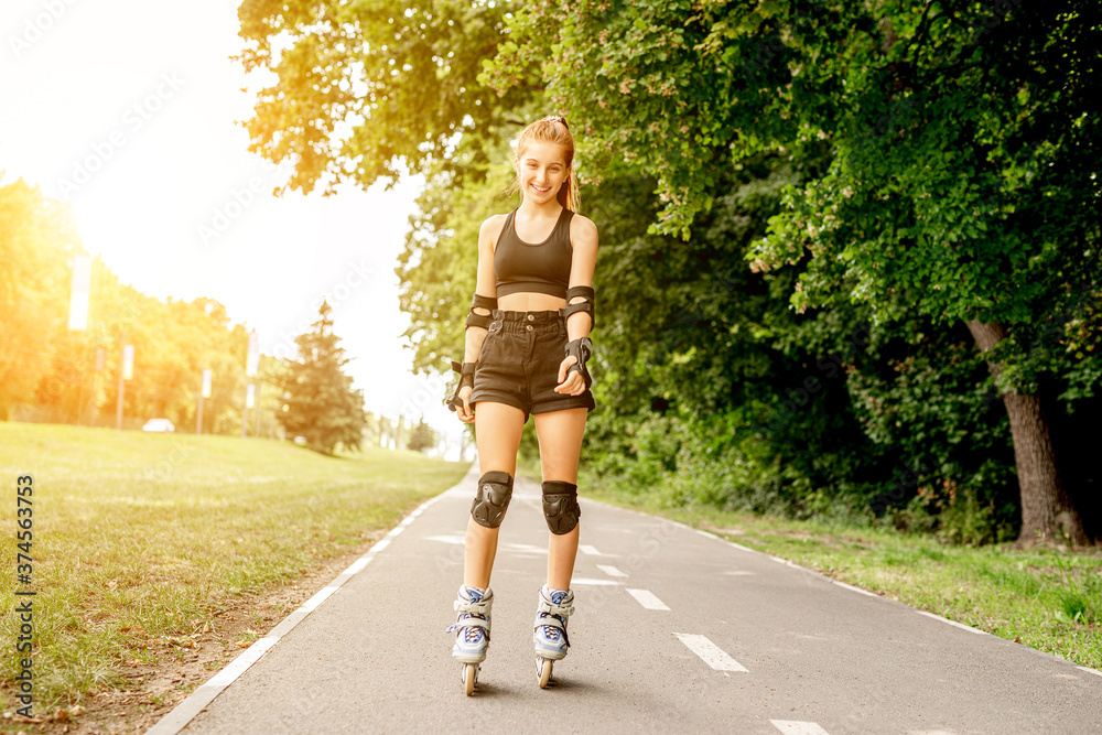 Teenage girl in sportswear roller skating Teenage girl in sportswear roller skating