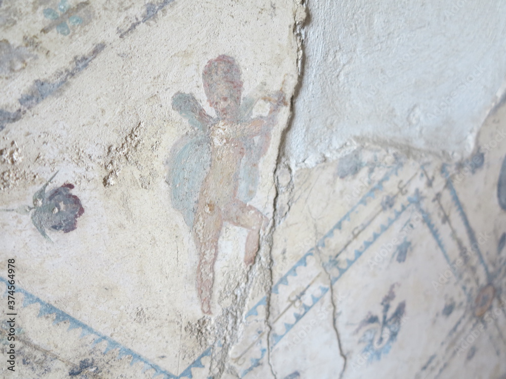 Fototapeta premium old stone wall with angel painted on