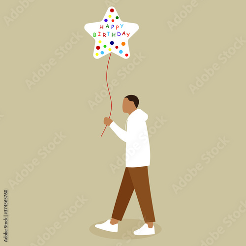 Man holding a balloon saying "Happy Birthday"