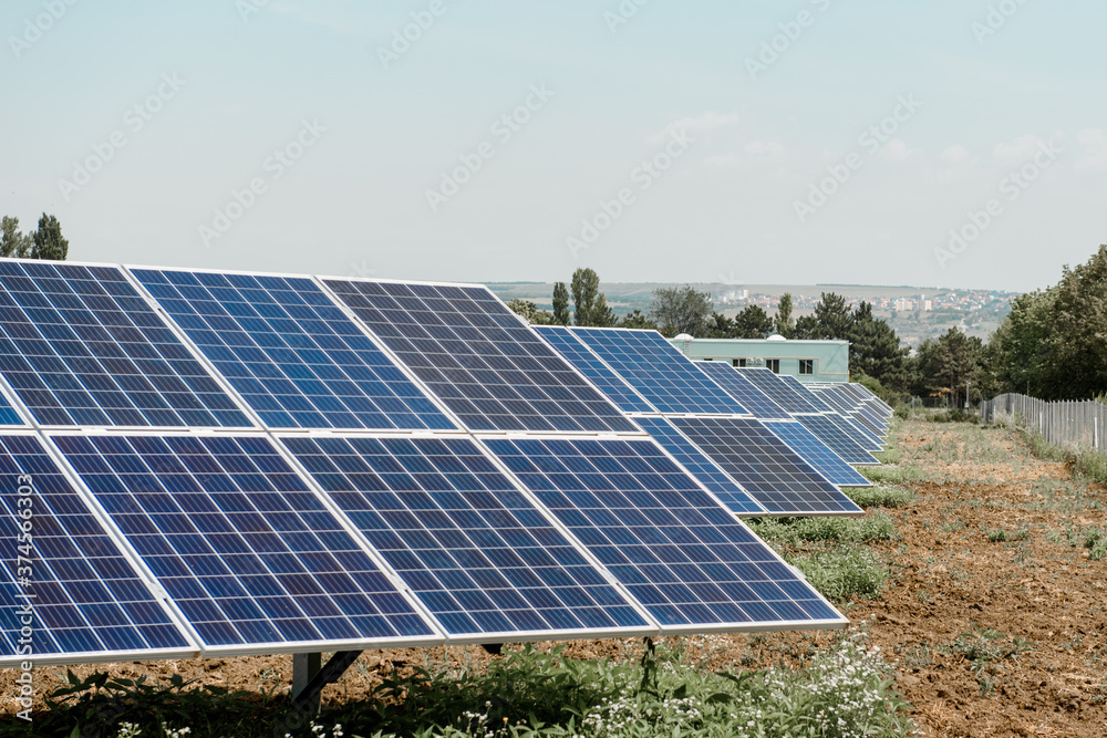 Photovoltaic power plant. Solar photovoltaic panels on blue sky background Photovoltaic power plant. Solar photovoltaic panels on blue sky background