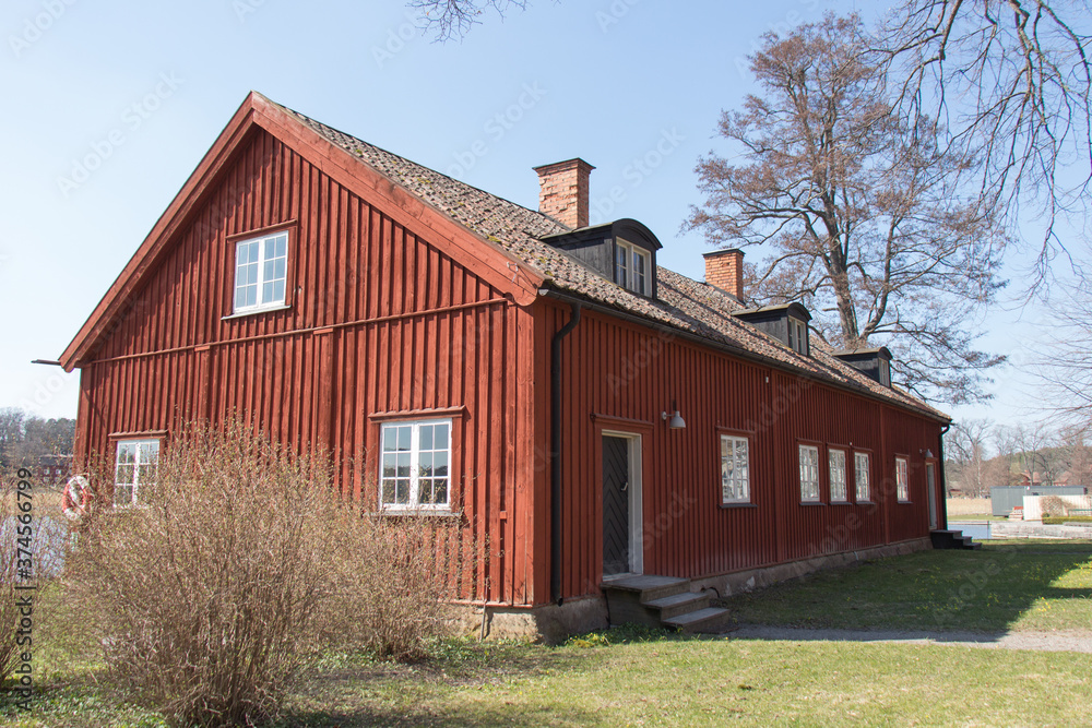 Mariefred, Sweden - April 20 2019: the exterior view of typical old swedish red house in a sunny day on April 20 2019 in Mariefred, Sweden.