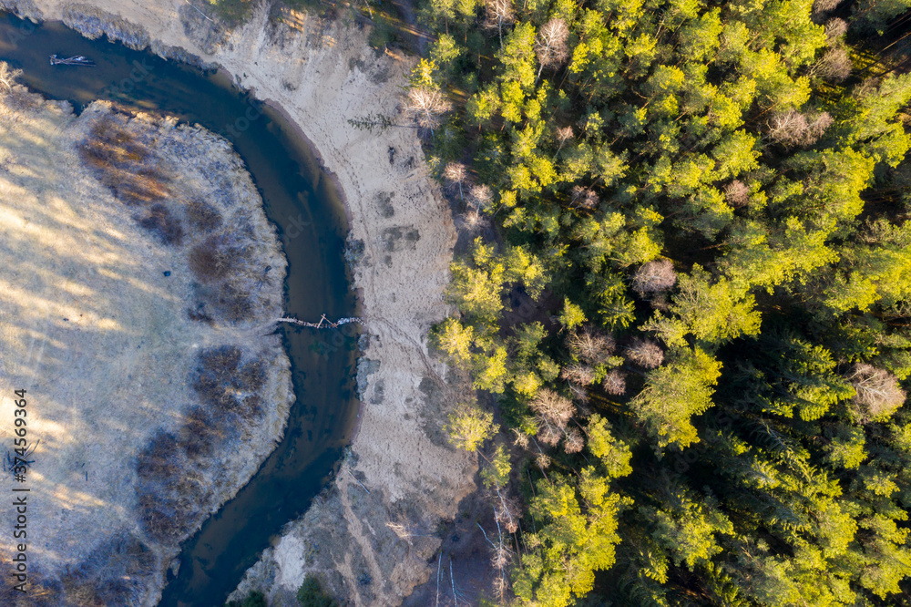 Drone shot flying on spring river in forest Drone shot flying on spring river in forest