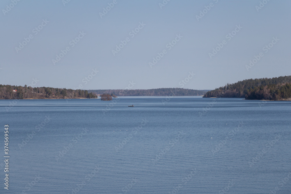 Peacefull landscape with boat in the lake Malaren and forest on background, Sweden. Peacefull landscape with boat in the lake Malaren and forest on background, Sweden.