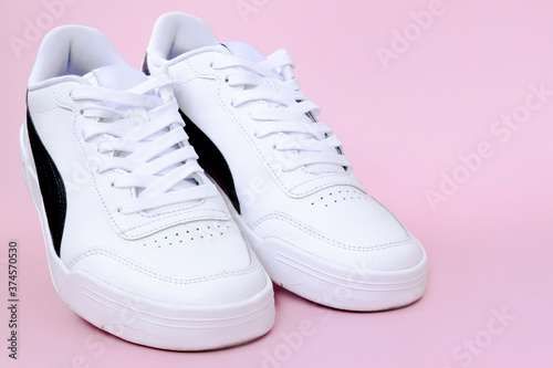 Mens sneakers on a pink background.