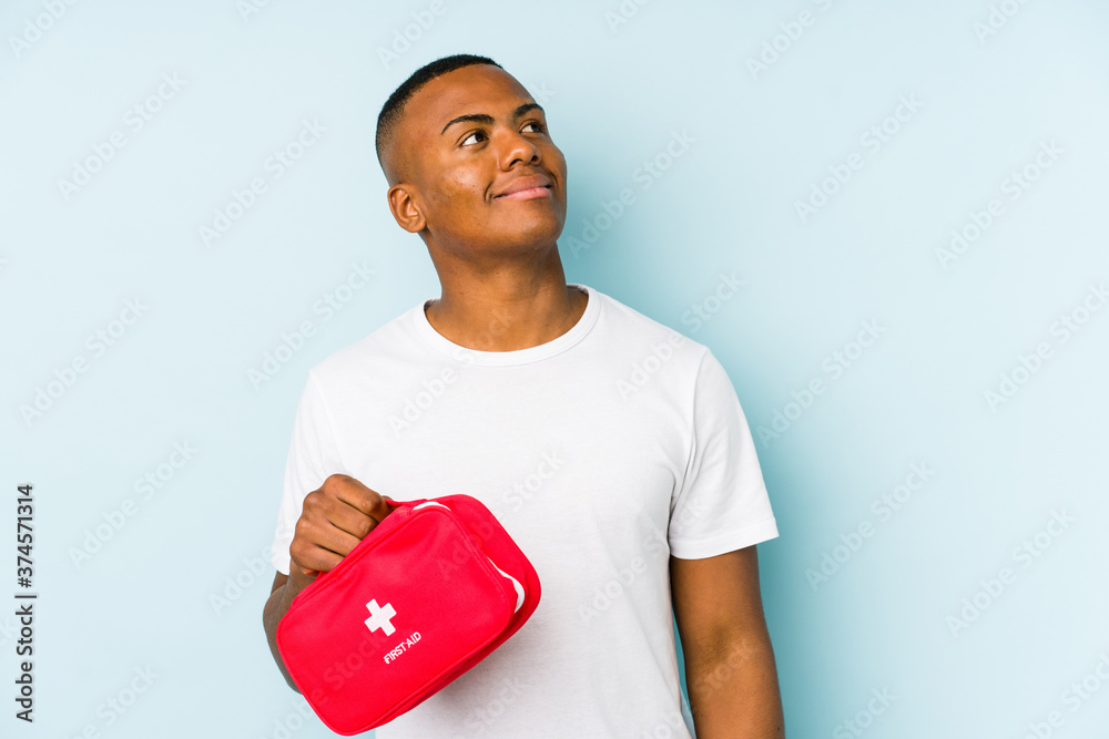Young latin man doing first aid isolated dreaming of achieving goals and purposes Young latin man doing first aid isolated dreaming of achieving goals and purposes