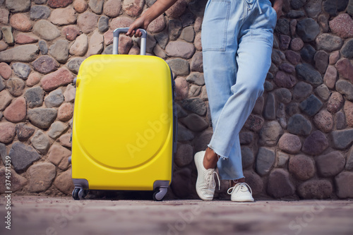 Woman with luggage outdoor. Travel and holiday concept