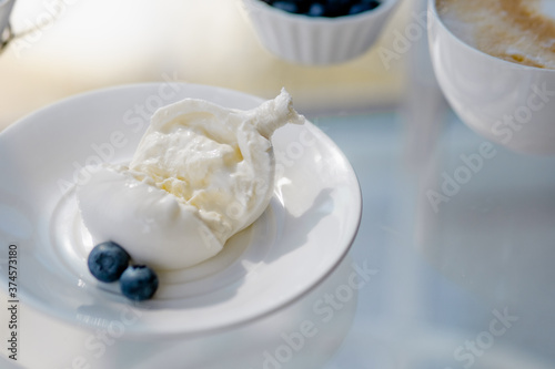 breakfast with burrata and cappuccino, honey and berries.