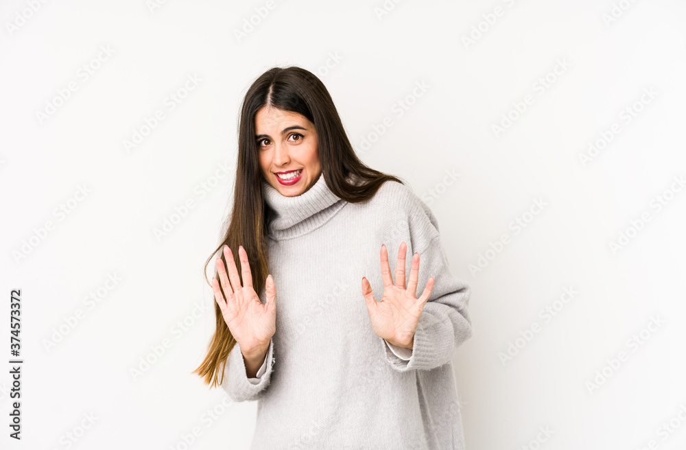 Young caucasian woman isolated on a white background rejecting someone showing a gesture of disgust. Young caucasian woman isolated on a white background rejecting someone showing a gesture of disgust.
