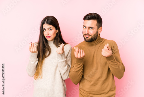 Young caucasian couple isolated showing that she has no money.
