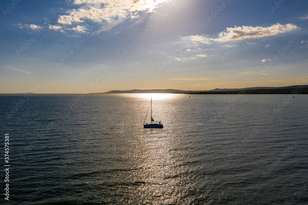 Fototapeta premium Sailing boat is waiting for the sunset on the lake Balaton