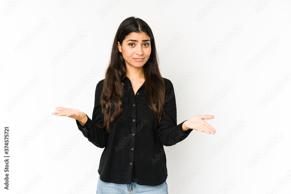 Young indian woman isolated on purple background makes scale with arms, feels happy and confident. Young indian woman isolated on purple background makes scale with arms, feels happy and confident.